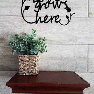 Black metal wall art sign. Love grows here with two tulip surrounding script.s